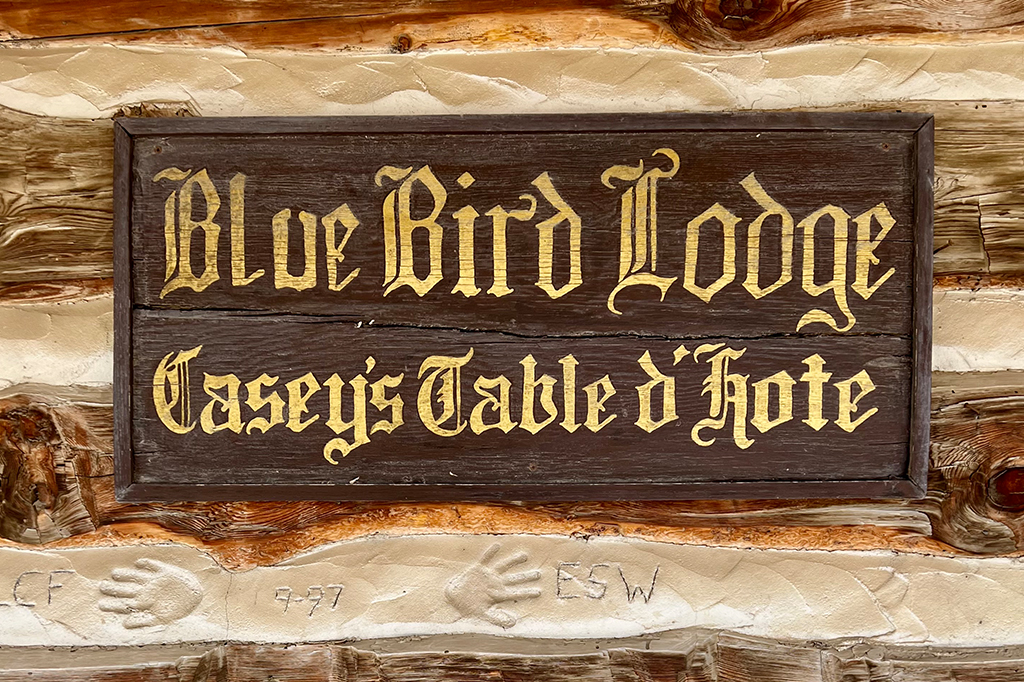 A sign for the Bluebird Lodge in Gold Hill